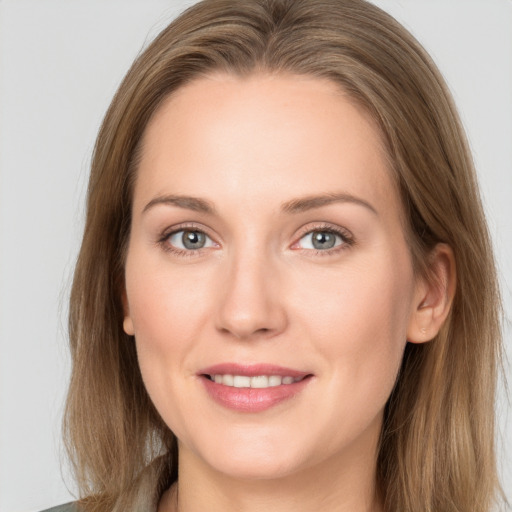 Joyful white young-adult female with long  brown hair and grey eyes