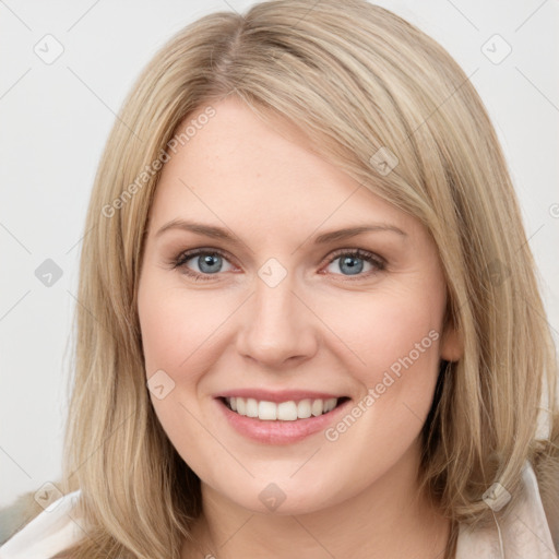 Joyful white young-adult female with long  brown hair and blue eyes