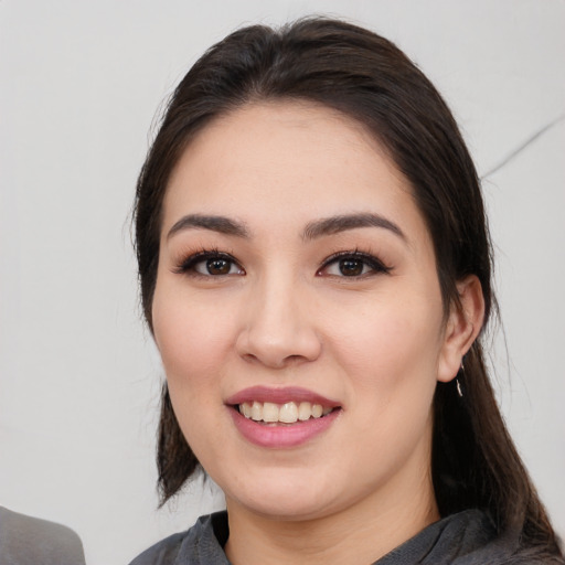 Joyful white young-adult female with medium  black hair and brown eyes