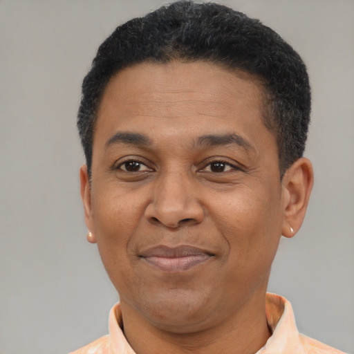 Joyful latino adult male with short  black hair and brown eyes