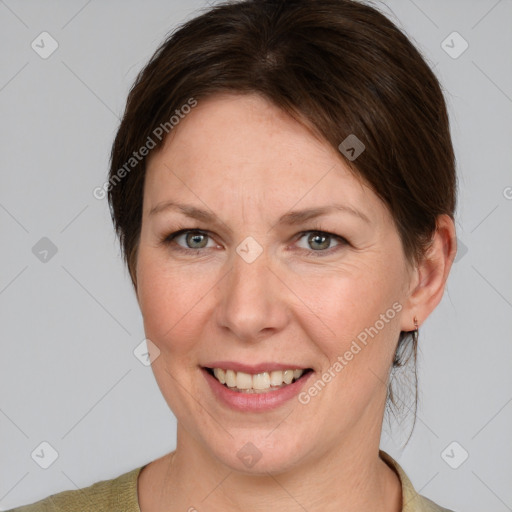 Joyful white adult female with medium  brown hair and grey eyes