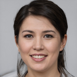 Joyful white young-adult female with medium  brown hair and brown eyes