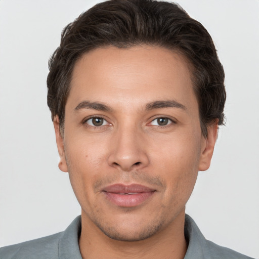 Joyful white adult male with short  brown hair and brown eyes