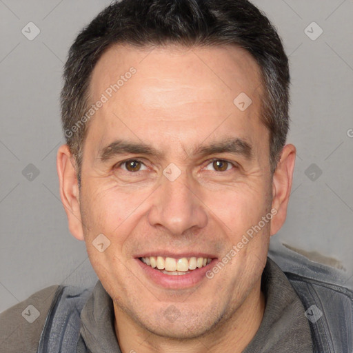 Joyful white adult male with short  brown hair and brown eyes