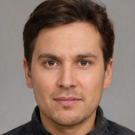 Joyful white adult male with short  brown hair and grey eyes