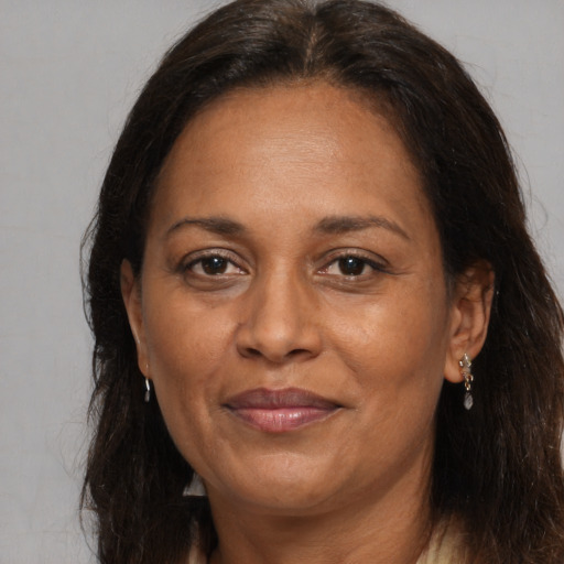 Joyful latino adult female with medium  brown hair and brown eyes