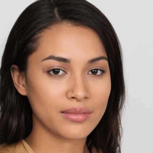 Joyful latino young-adult female with long  brown hair and brown eyes