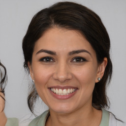 Joyful white young-adult female with medium  brown hair and brown eyes