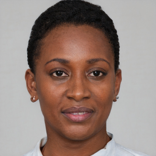 Joyful black young-adult female with short  black hair and brown eyes