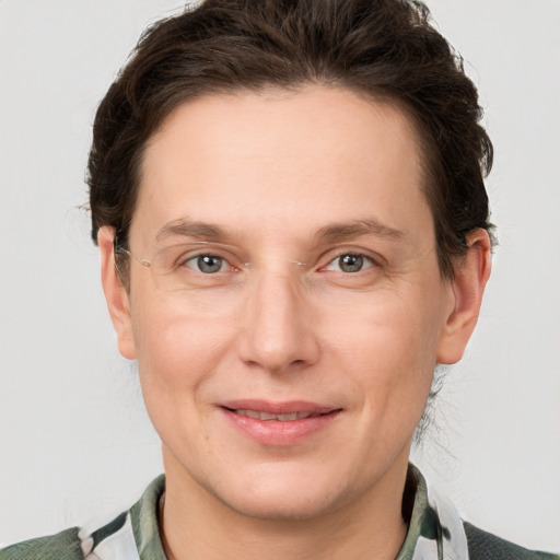 Joyful white adult female with medium  brown hair and grey eyes