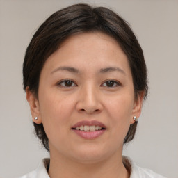 Joyful white young-adult female with medium  brown hair and brown eyes