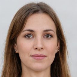 Joyful white young-adult female with long  brown hair and green eyes