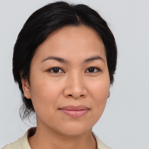 Joyful asian young-adult female with medium  brown hair and brown eyes