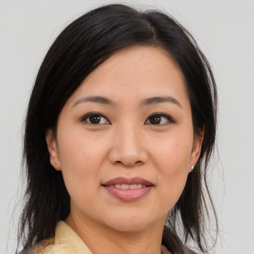Joyful asian young-adult female with medium  brown hair and brown eyes
