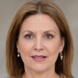 Joyful white adult female with medium  brown hair and grey eyes