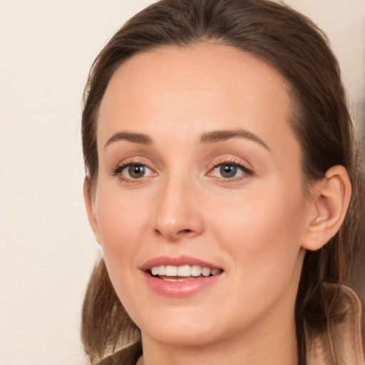 Joyful white young-adult female with long  brown hair and brown eyes