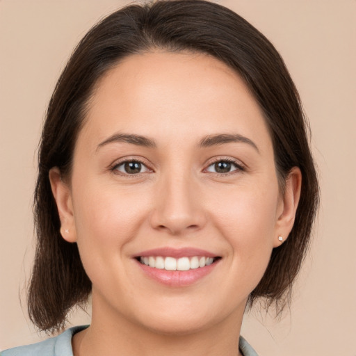 Joyful white young-adult female with medium  brown hair and brown eyes