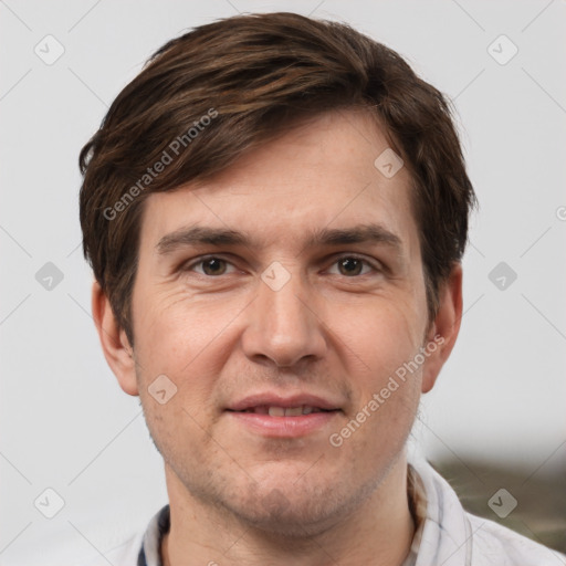 Joyful white adult male with short  brown hair and grey eyes