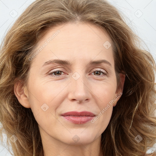 Joyful white adult female with long  brown hair and brown eyes