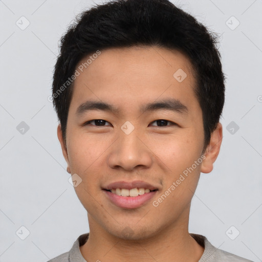 Joyful asian young-adult male with short  brown hair and brown eyes