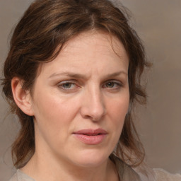 Joyful white adult female with medium  brown hair and grey eyes