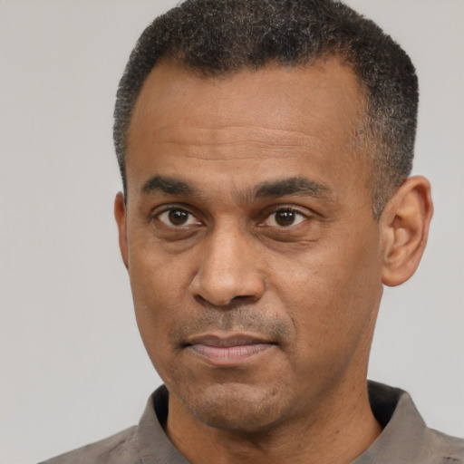 Neutral latino adult male with short  black hair and brown eyes