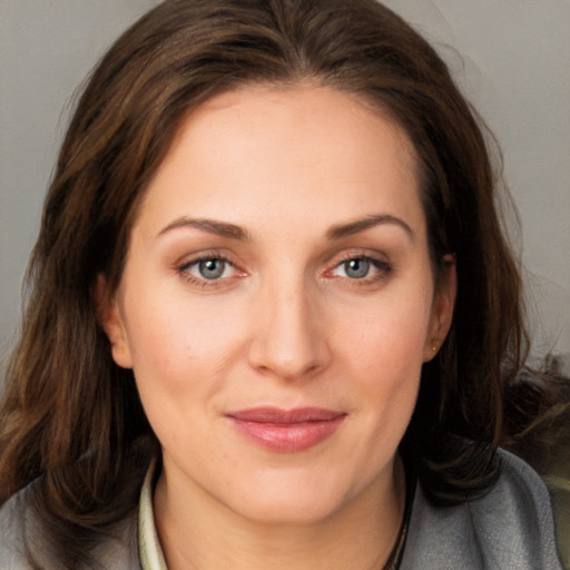 Joyful white young-adult female with medium  brown hair and blue eyes