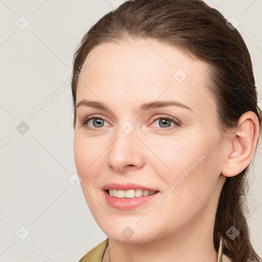 Joyful white young-adult female with medium  brown hair and grey eyes