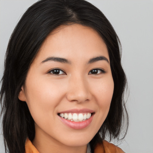 Joyful white young-adult female with long  brown hair and brown eyes