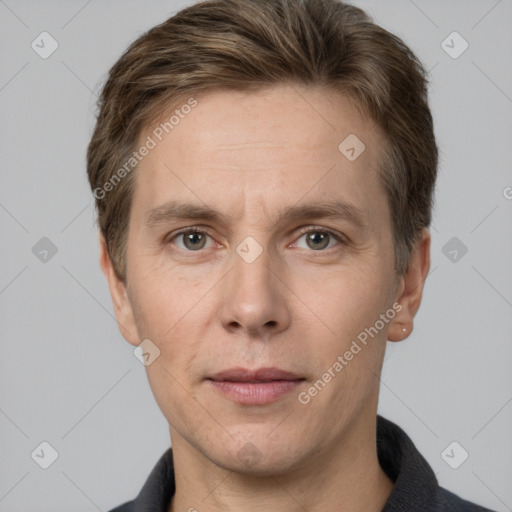 Joyful white adult male with short  brown hair and grey eyes