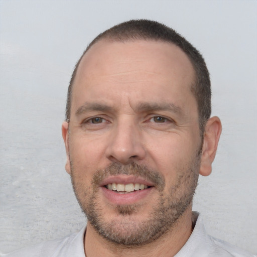 Joyful white adult male with short  brown hair and brown eyes