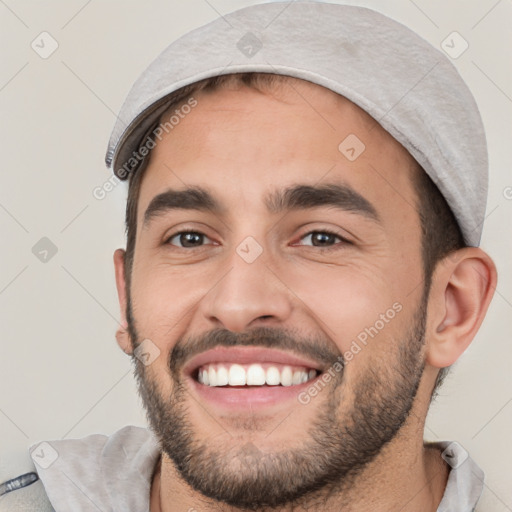 Joyful white young-adult male with short  black hair and brown eyes