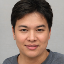 Joyful asian young-adult male with short  brown hair and brown eyes