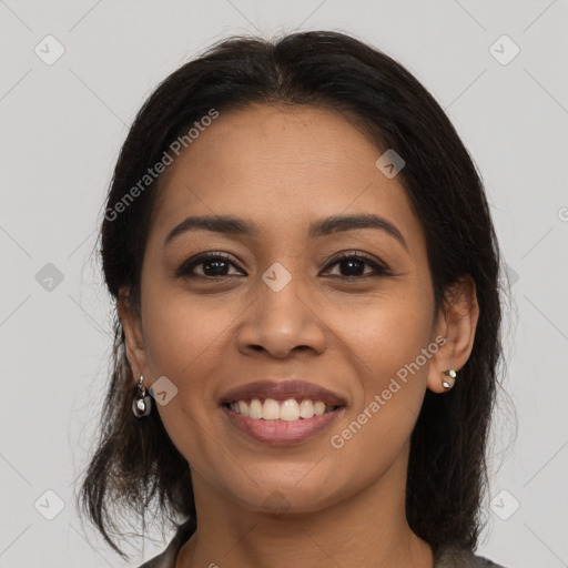 Joyful latino young-adult female with medium  brown hair and brown eyes