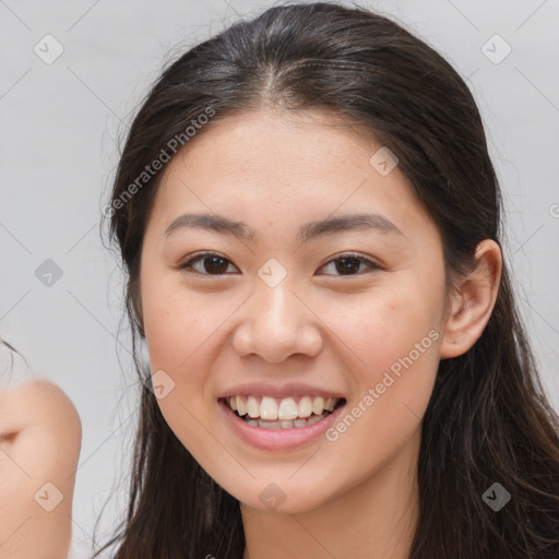 Joyful white young-adult female with long  brown hair and brown eyes