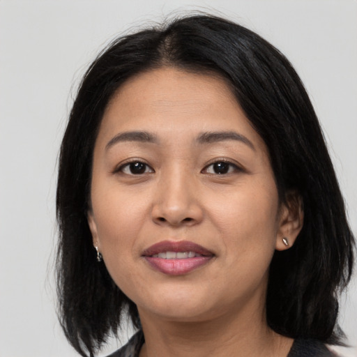 Joyful asian young-adult female with medium  black hair and brown eyes