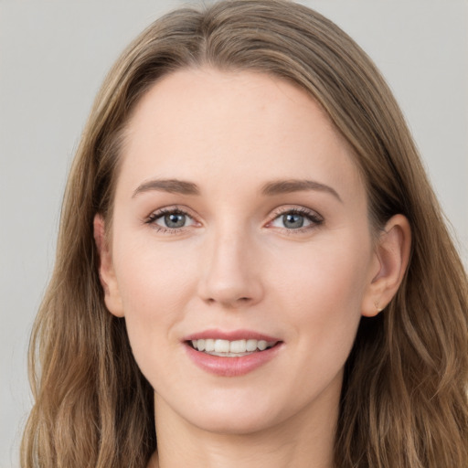 Joyful white young-adult female with long  brown hair and grey eyes