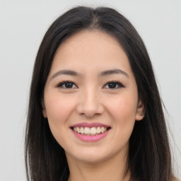 Joyful asian young-adult female with long  brown hair and brown eyes