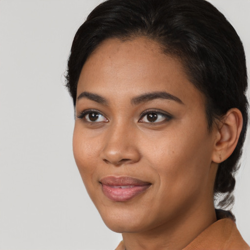 Joyful latino young-adult female with short  black hair and brown eyes