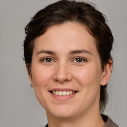 Joyful white young-adult female with medium  brown hair and grey eyes