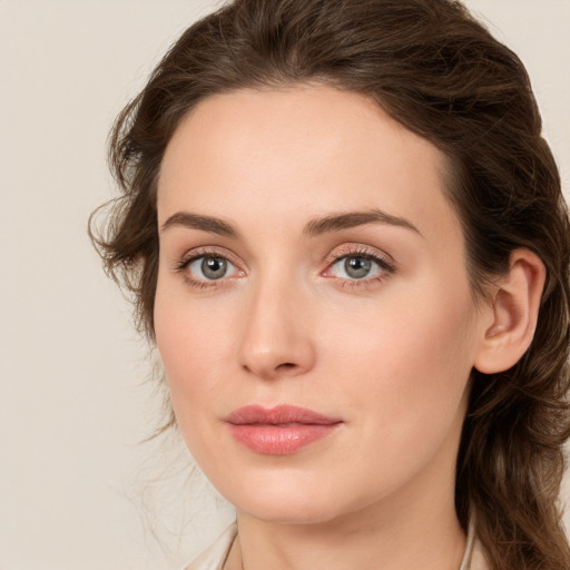 Joyful white young-adult female with long  brown hair and green eyes