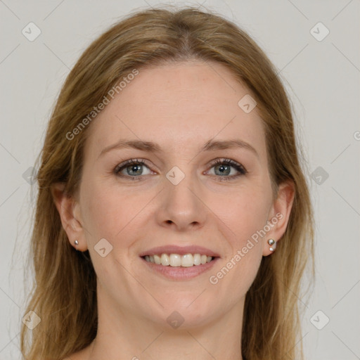 Joyful white adult female with long  brown hair and grey eyes