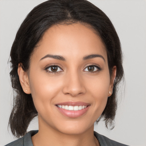 Joyful white young-adult female with medium  brown hair and brown eyes