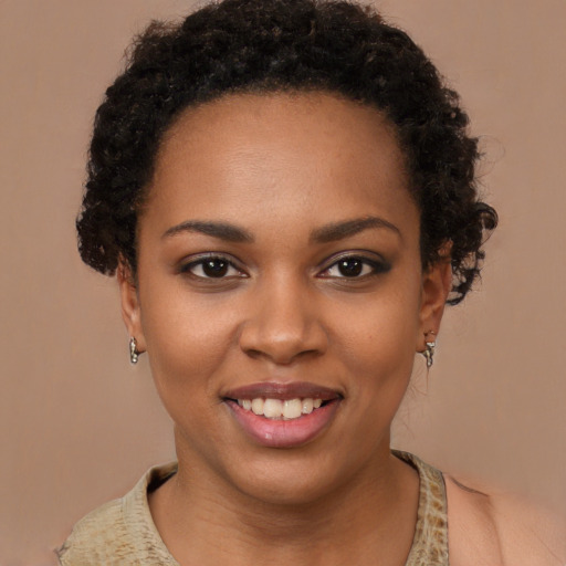 Joyful black young-adult female with short  brown hair and brown eyes