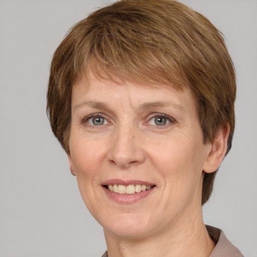 Joyful white adult female with short  brown hair and grey eyes