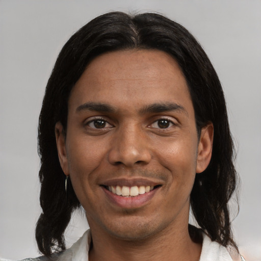 Joyful white young-adult male with medium  black hair and brown eyes