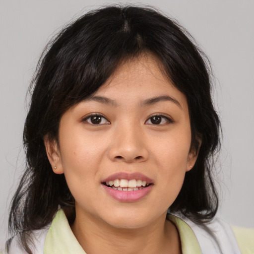 Joyful asian young-adult female with medium  brown hair and brown eyes