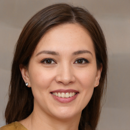 Joyful white young-adult female with medium  brown hair and brown eyes