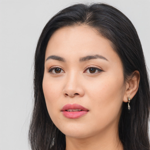 Joyful asian young-adult female with long  black hair and brown eyes
