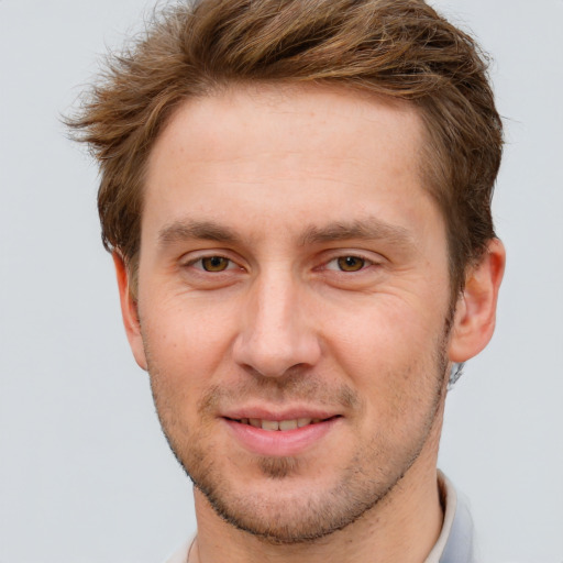 Joyful white young-adult male with short  brown hair and grey eyes